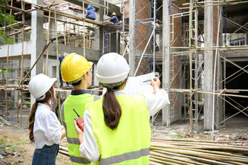 back view, A group of engineer, architect or construction inspector at the construction site