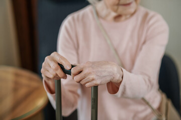 Good-looking senior woman sitting with a suitcase in a hotel room
