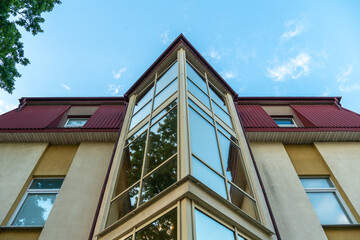 View of the facade of an office building with large Windows. New wide double glazed windows installed in a modern building.