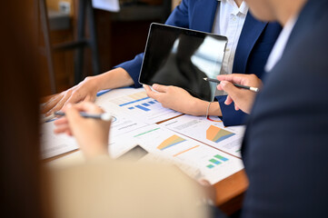 A team of business financial analysts planning their strategy together in the meeting.