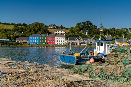 old wooden fishing boat and fishing nets and crab traps in Bantry Bay withe downtown Bantry in the background