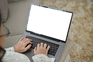 Above view, A female relaxes using a notebook laptop in her living room. laptop mockup