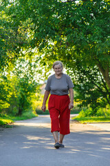 grandma is walking down the road. Selective focus.