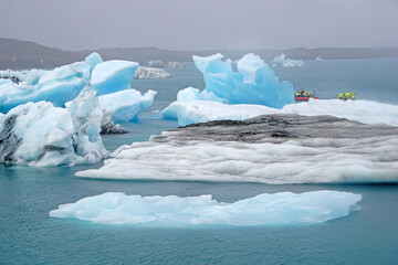 Jokulsarlon - glacial lagoon in Iceland, boats with tourists on second plan