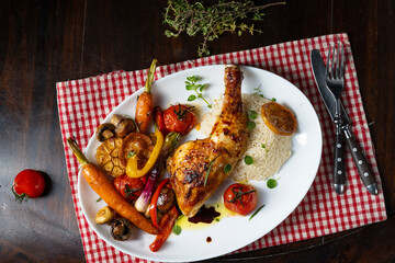 Rustic fried chicken legs with assorted vegetables and rice