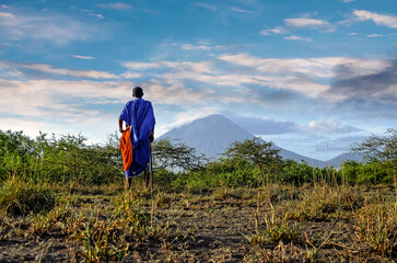 Masai close-up looking at the holy volcano of Ol Doinyo Lengai in Tanzania - obrazy, fototapety, plakaty