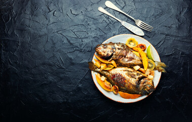 Baked gilthead or dorado fish in fruit.