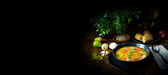 Hearty rustic pea soup with bacon and sausage