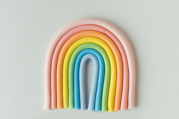 Cartoon edible rainbow made of confectionery mastic on the white background. Multicolored cake...