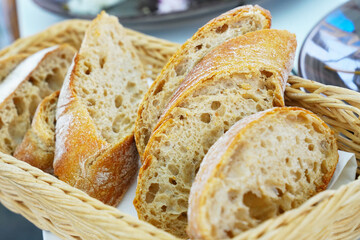 toasted ciabatta bread slices for making bruschettas. Crispy Slices of fresh traditional Italian ciabatta bread. Fresh pastries in rustic style.
