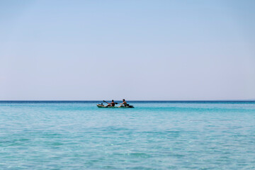 Fototapeta na wymiar Happy two teenagers kayaking together in amazing clear water of Aegean sea.Happy family adventures concept