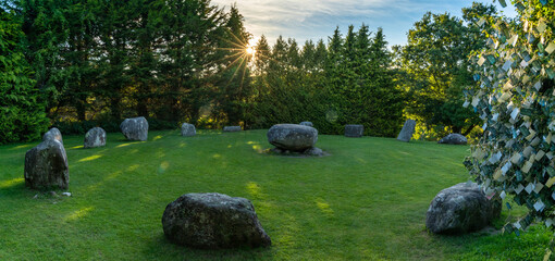 panorama landscape of the Kenmare Standing Stones and Wishing Tree in warm evening light with a...
