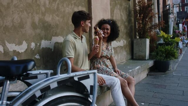 Stylish young couple enjoying ice cream together in old European town