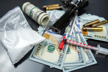 Plastic bags of cocaine, US dollar bills with a gun.