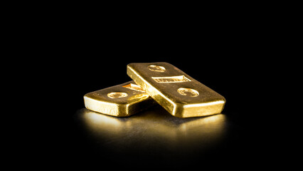 close up pure gold bar ingot put on the black color leather surface background represent the...