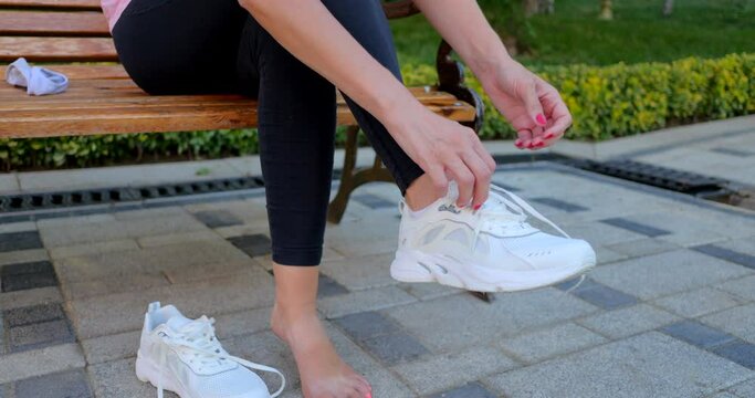 Girl kneading her feet after a run. 