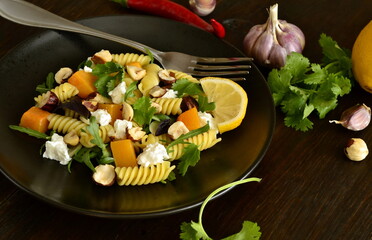 Pasta with baked pumpkin, feta, herbs and hazelnuts