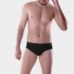 Mockup of black underpants on a brutal guy, male panties, isolated on background, front view.