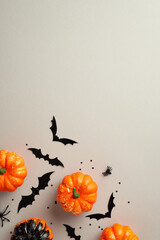 Halloween spooky decor concept. Top view photo of small pumpkins bat silhouettes spiders and...
