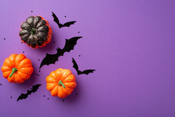 Halloween concept. Top view photo of small pumpkins bat silhouettes and star shaped confetti on...