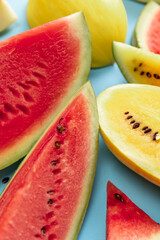 Top view of ripe juicy red and yellow watermelon slices over colorful background. Design for wallpaper, greeting season card. Closeup