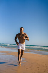 Fototapeta na wymiar Chico joven tatuado y musculoso en bañador y ropa interior en la playa