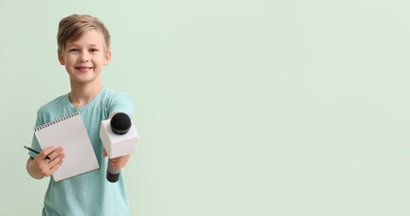Little journalist with microphone and notebook on color background with space for text - obrazy, fototapety, plakaty