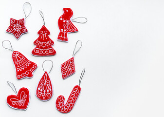 New Year and Christmas hand made retro style decorations made of red felt fabric on white paper. Flat lay, copy space