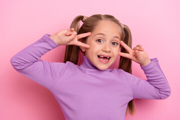 Photo of young little charming girl laughing showing v sign say hello to new friends in...