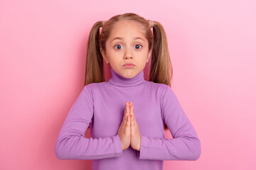 Photo of little lovely girl asking parents for cool expensive birthday present isolated on pink...