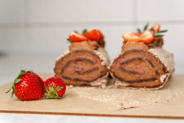 Homemade cake roll with chocolate and fresh strawberry. Chocolate swiss cake. Sweet roll cake. Rolled with fruits. Wonderful dessert. Chocolate strawberry roll cake. Sponge roll with blueberries