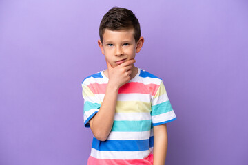 Little boy isolated on purple background thinking