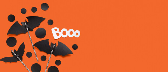 Composition with Halloween decor on orange background with space for text