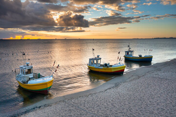 Cloudy sunrise on the beach of Baltic Sea in Sopot with fishing boats, Poland