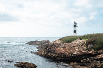 Fototapeta na wymiar lighthouse on a cliff facing the ocean
