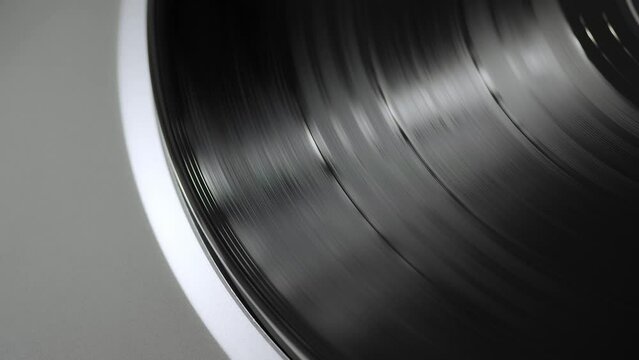 Close up of a silver modern vinyl turntable playing at home