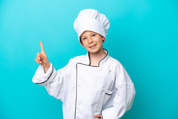 Little chef boy isolated on blue background showing and lifting a finger in sign of the best