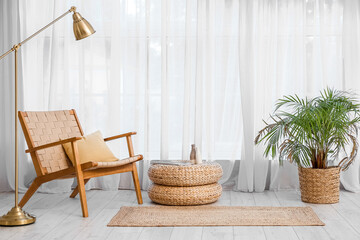 Interior of cozy living room with rattan poufs and armchair