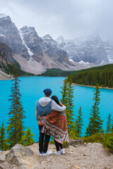  Lake moraine during a cold snowy day in Canada, turquoise waters of the Moraine lake with snow....