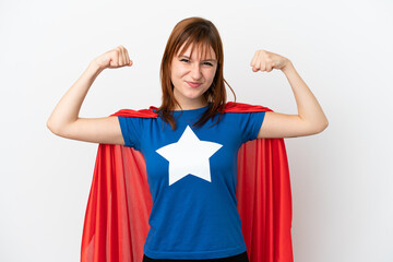 Redhead girl isolated on white background in superhero costume and doing strong gesture