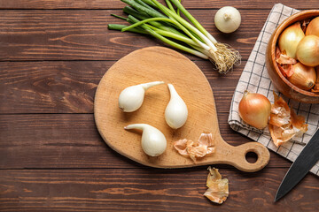 Composition with different onion on wooden background