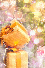 Fototapeta na wymiar Golden New Year and Christmas gifts on a blurry background with bokeh.