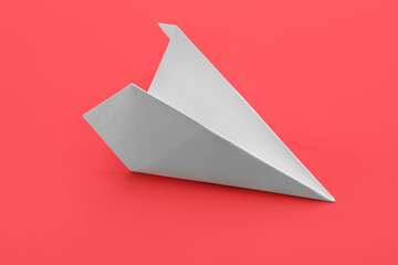 White paper plane on red background