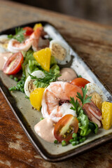 prawn and egg salad on rustic wood table