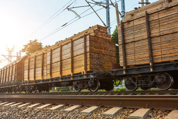 Treated wood blocks boards loaded onto freight wagons, sent by train to destination.