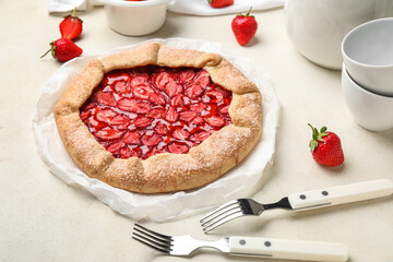 Sweet strawberry galette on light background