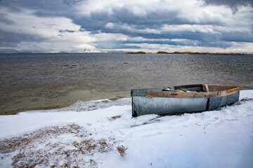 Boat on snow. Winter landscape composition.