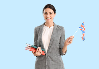 Female English teacher with UK flag ad books on blue background