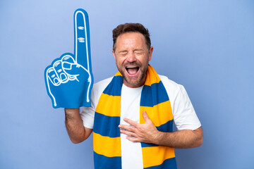 Middle age caucasian sports fan man isolated on blue background smiling a lot