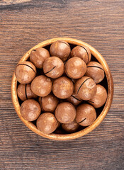 Top view of a bowl full of macadamia nuts.